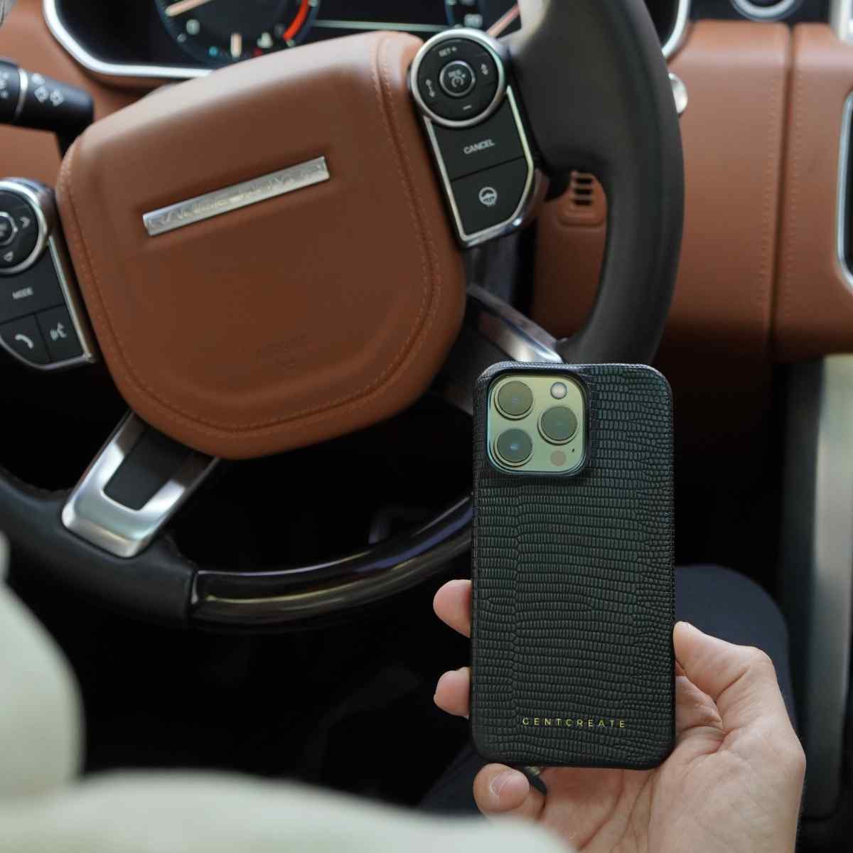 A man is holding an iPhone 13 Lizard Black Leather Case by Gentcreate A man is holding an iPhone 13 Lizard Black Leather Case by Gentcreate