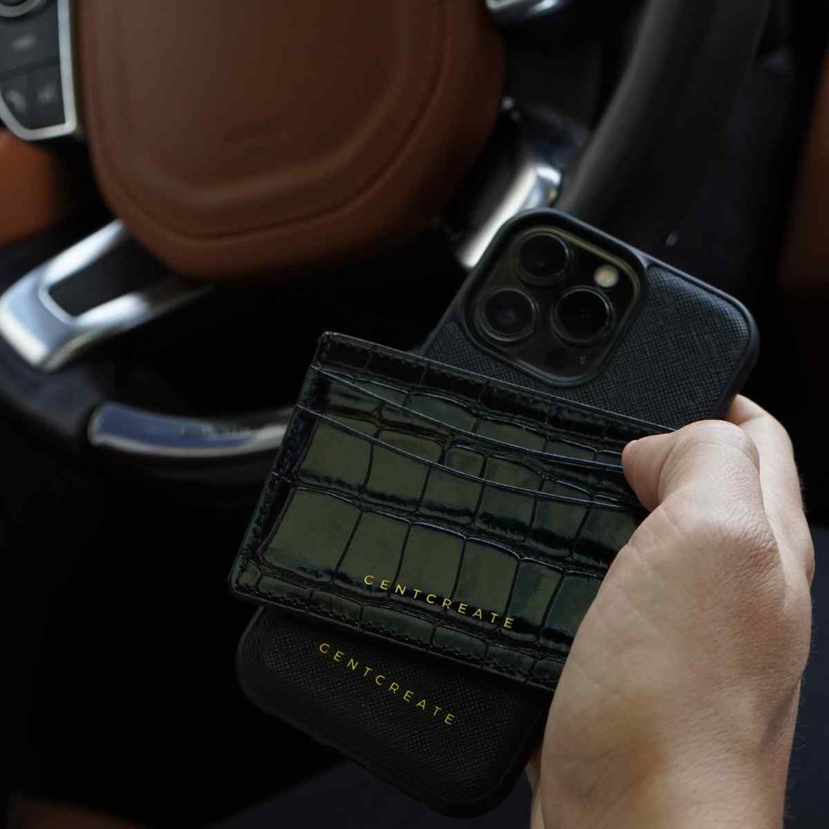 A man is holding a Black Full Grain Leather iPhone Case by Gentcreate A man is holding a Black Full Grain Leather iPhone Case by Gentcreate
