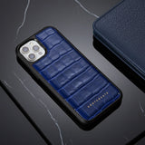 Blue crocodile-patterned phone case on a dark surface with 'GENTCREATE' branding.