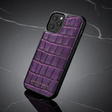 Purple crocodile-patterned phone case on a dark gray background