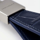 Close-up of a blue crocodile leather keychain with stitching detail, branded 'GENTCREATE.