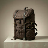 Brown backpack with leather straps on a neutral background