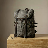 Gray backpack with leather straps on a beige pillar product photography GENTCREATE