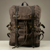 Brown backpack with leather straps on a neutral background