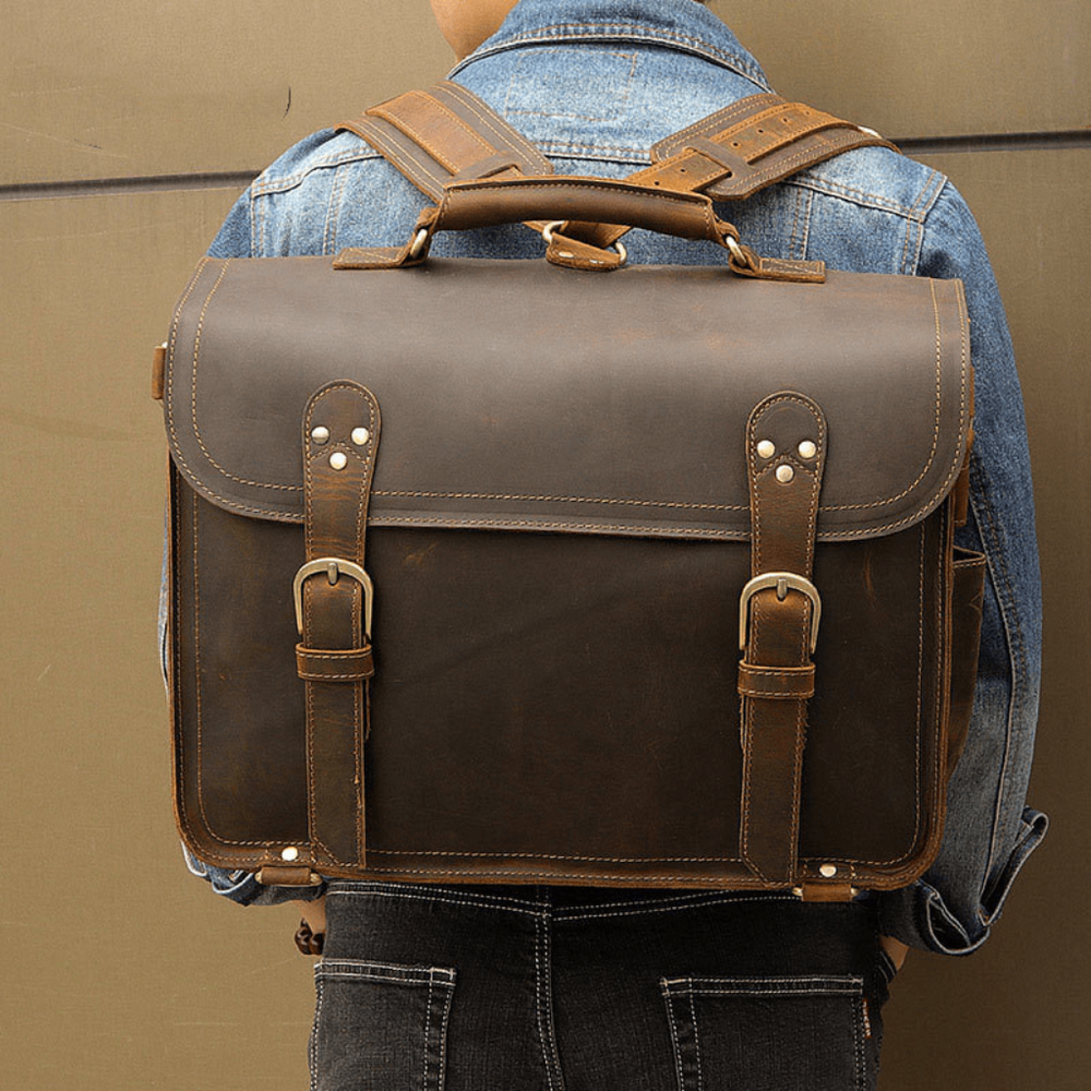 Messenger Bag Viri i skinn Mann som bærer en premium lær brun ryggsekk messenger-veske på ryggen fra luksus motemerke Gentcreate