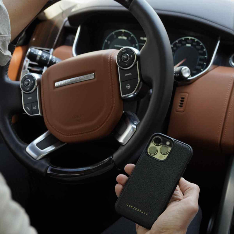 A Man Is Holding An iPhone Saffiano Black Leather Case By Gentcreate