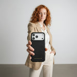 Woman holding a black phone case with 'GENTLEBEAR' branding against a plain background