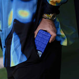 The man is putting a blue Gentcreate iPhone 15 Pro Max case into his pants.