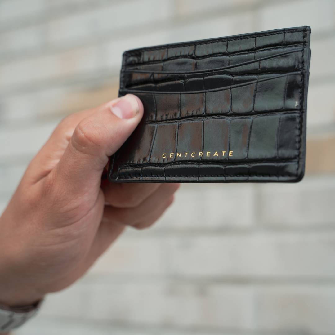 The man is holding a black crocodile cardholder by Gentcreate luxury tech brand