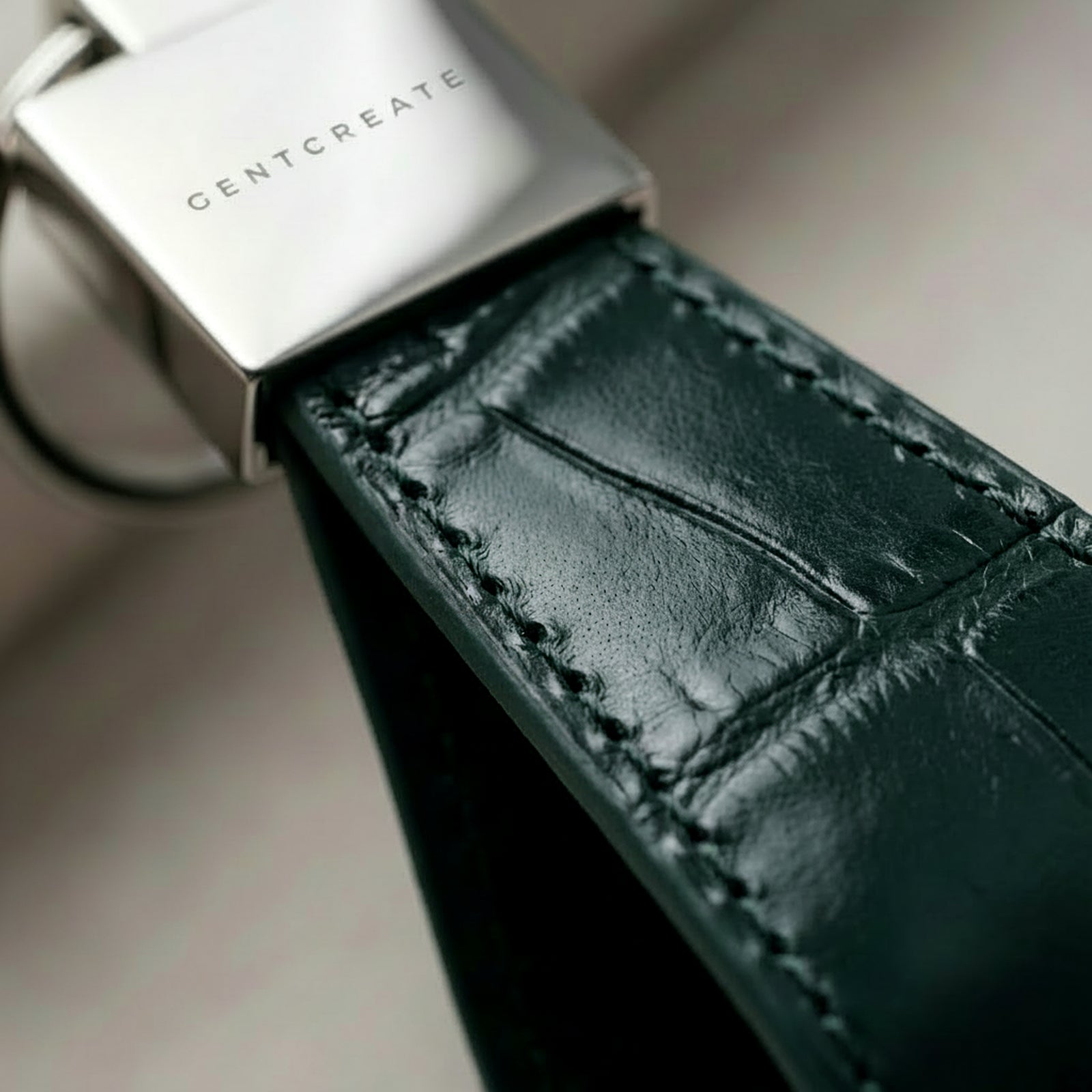 Dark green crocodile leather keychain extreme close up of leather grain