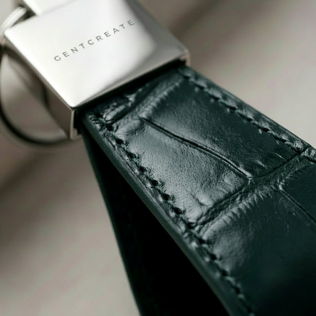 Dark green crocodile leather keychain extreme close up of leather grain
