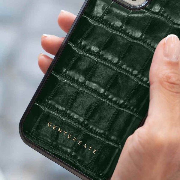 The woman is holding a green iPhone 15 Pro Max case by the luxury brand Gentcreate.