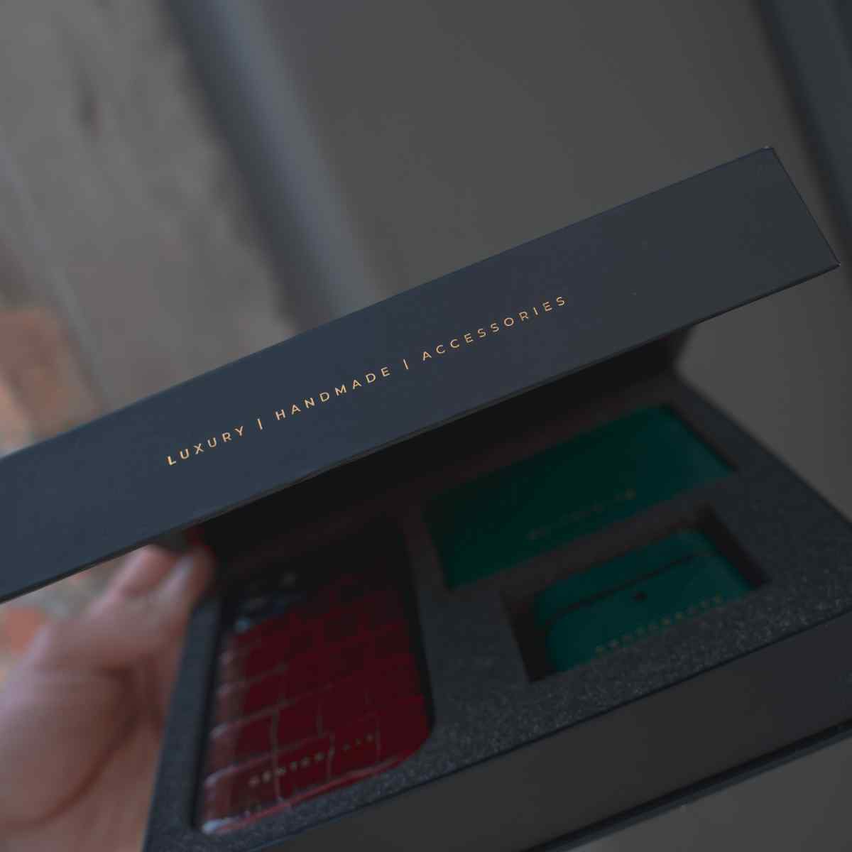 A man is holding a box from Gentcreate with luxury leather products inside