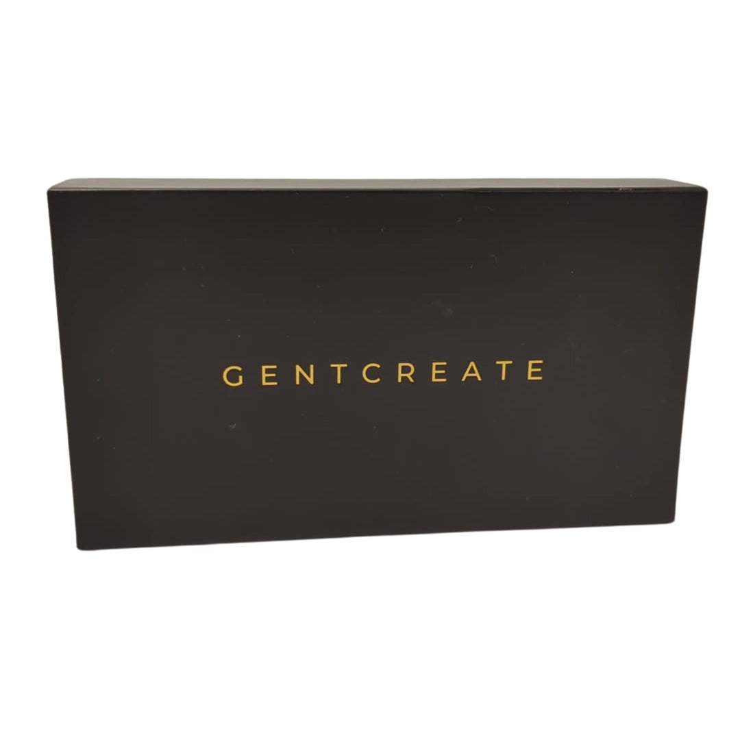 The closed GENTCREATE gift box, matte near-black with the name in gold