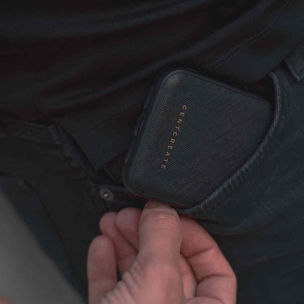 A man takes out a Saffiano pattern leather case from his pocket by Gentcreate
