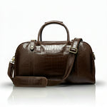 Brown leather handbag with a shoulder strap on a white background