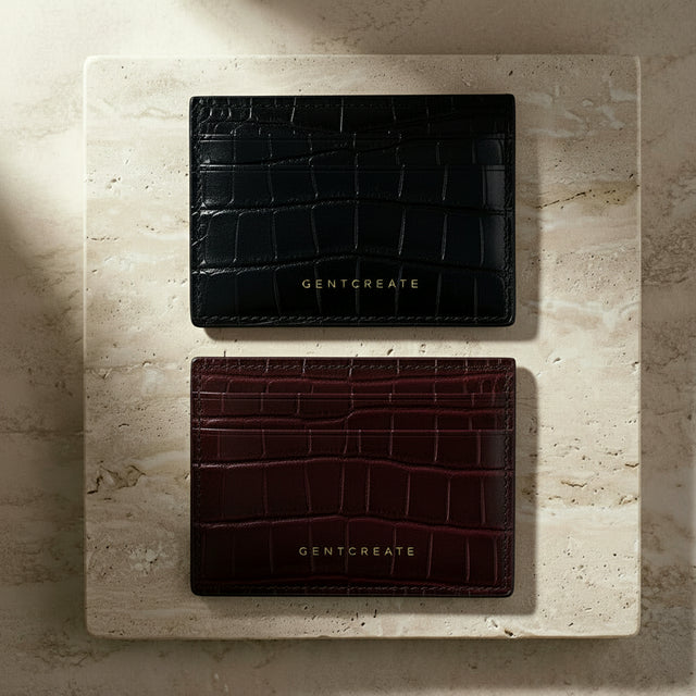Two black and burgundy leather card holders on a marble surface with 'GENTCREATE' branding.