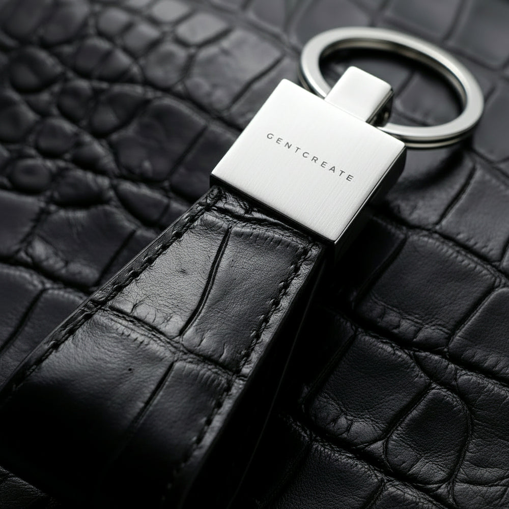 Keychain with 'GENTCREATE' branding on a black alligator leather surface