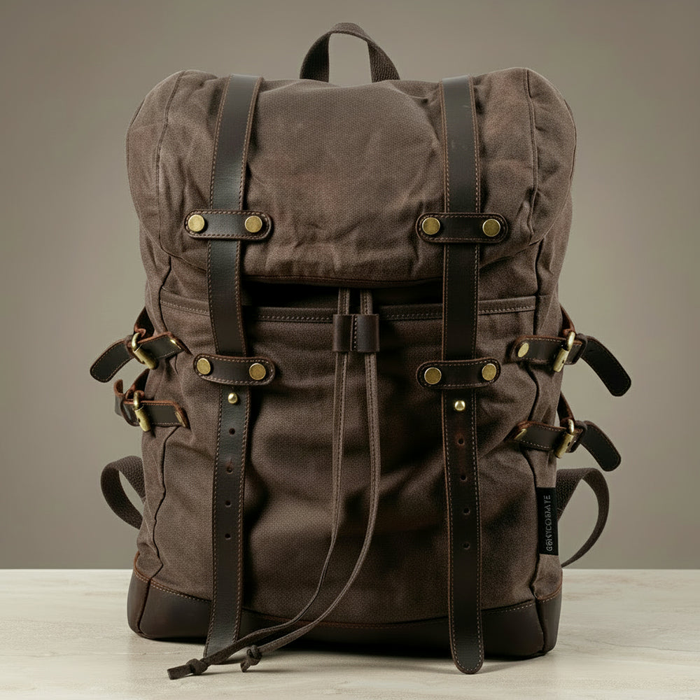 Brown backpack with leather straps on a neutral background