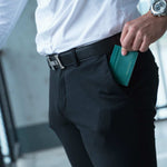 A man is holding a green leather lizard pattern card holder from the luxury fashion brand Gentcreate