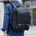 The man is carrying on his back a black leather backpack from the Gentcreate.