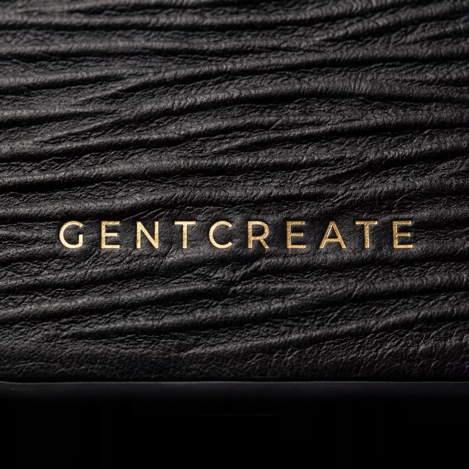 Close-up of iPhone case in wave leather pattern with GENTCREATE branding