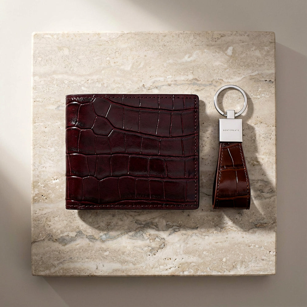 Burgundy crocodile leather wallet and crocodile keychain corporate leather gift bundle on a marble surface