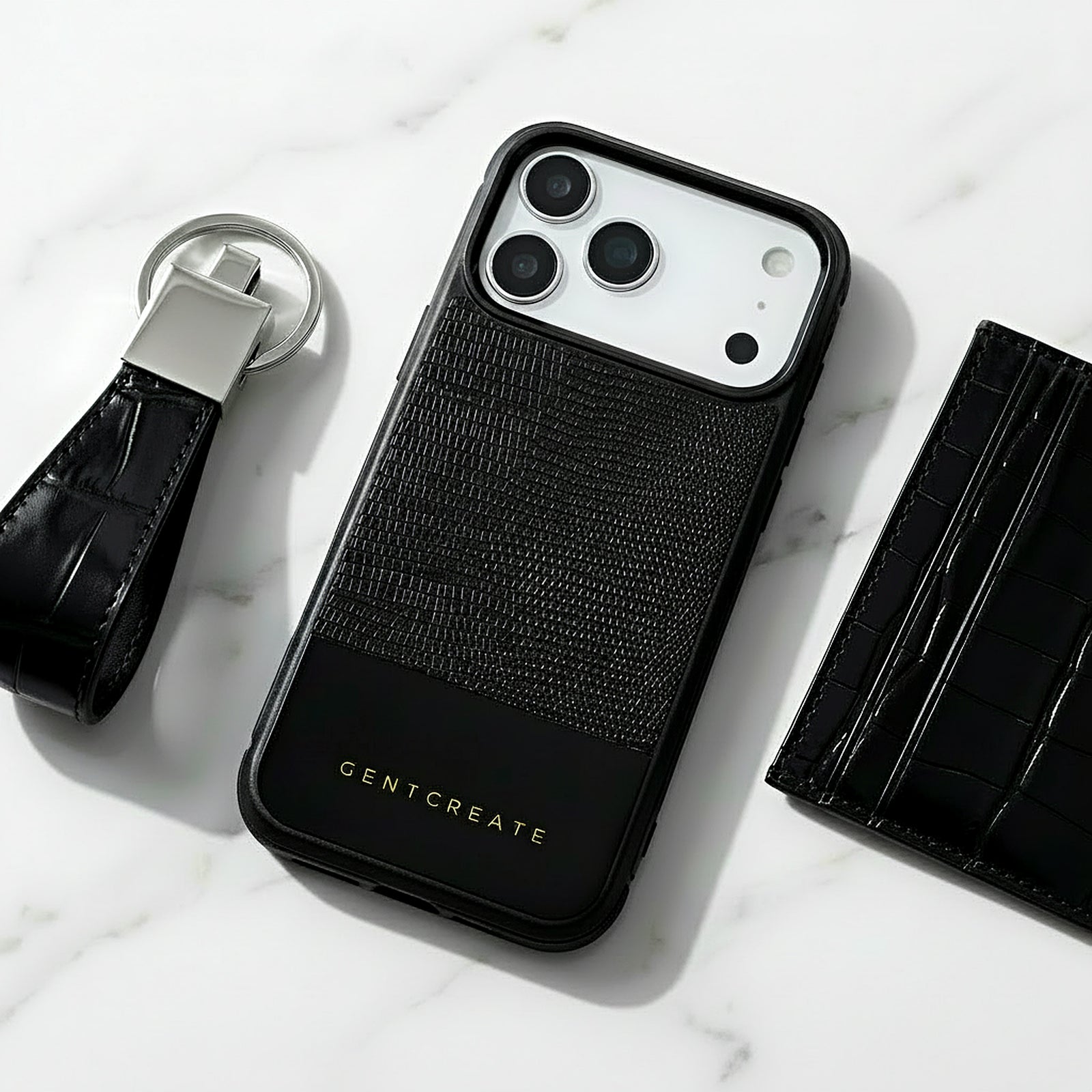 Ensemble coque iPhone 17 Pro Max en cuir lézard noir avec porte-clés et portefeuille sur surface en marbre, de la marque GENTCREATE