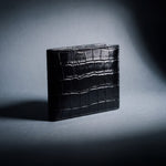 Black crocodile-embossed leather bifold wallet by GENTCREATE, studio still life