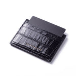 Black crocodile-embossed leather card holder by GENTCREATE standing with a card, on white