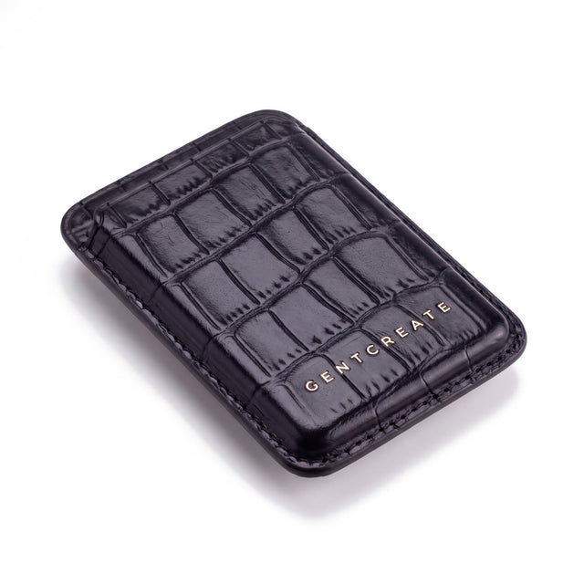 Black crocodile-embossed leather magnetic card wallet by GENTCREATE lying at an angle on white