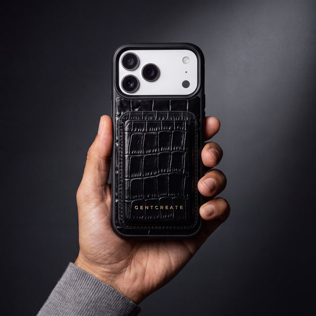 Man's hand holding a phone in a black crocodile-embossed case with the matching magnetic card wallet by GENTCREATE