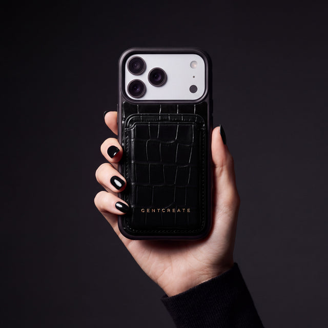 Woman's hand holding a phone in a black crocodile-embossed case with the matching magnetic card wallet by GENTCREATE