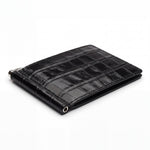 Closed black glossy crocodile-embossed leather money clip wallet by GENTCREATE with its silver clip, on white
