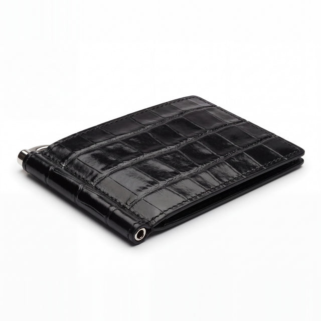 Closed black glossy crocodile-embossed leather money clip wallet by GENTCREATE with its silver clip, on white
