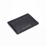Black lizard-embossed leather business card holder by GENTCREATE lying at an angle on white