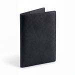 Closed black lizard-embossed leather passport holder by GENTCREATE standing on white