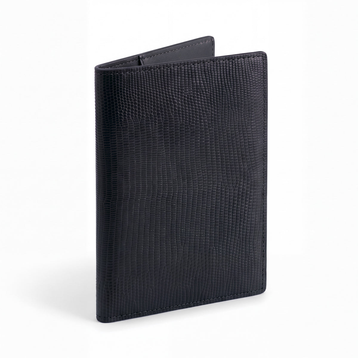 Closed black lizard-embossed leather passport holder by GENTCREATE standing on white