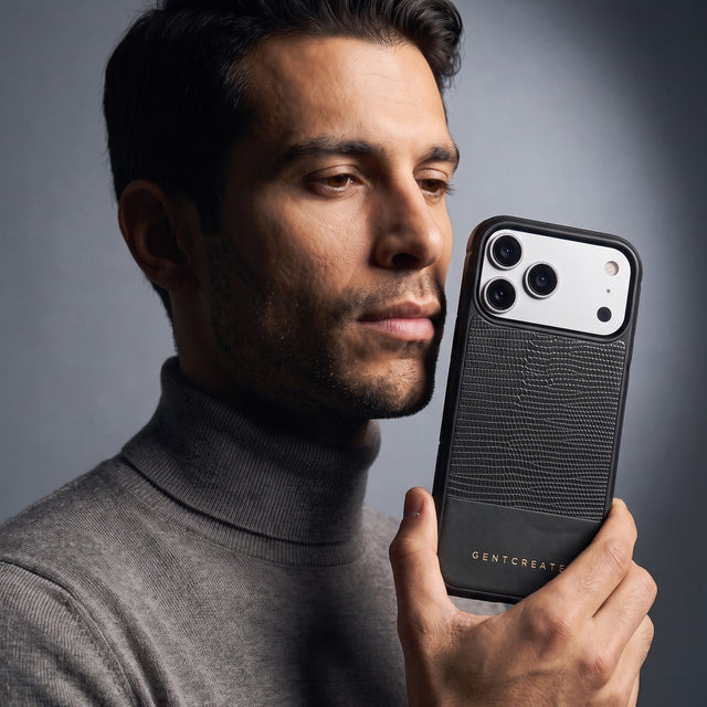 Man holding a black lizard-embossed leather iPhone 18 Pro Max case by GENTCREATE beside his face