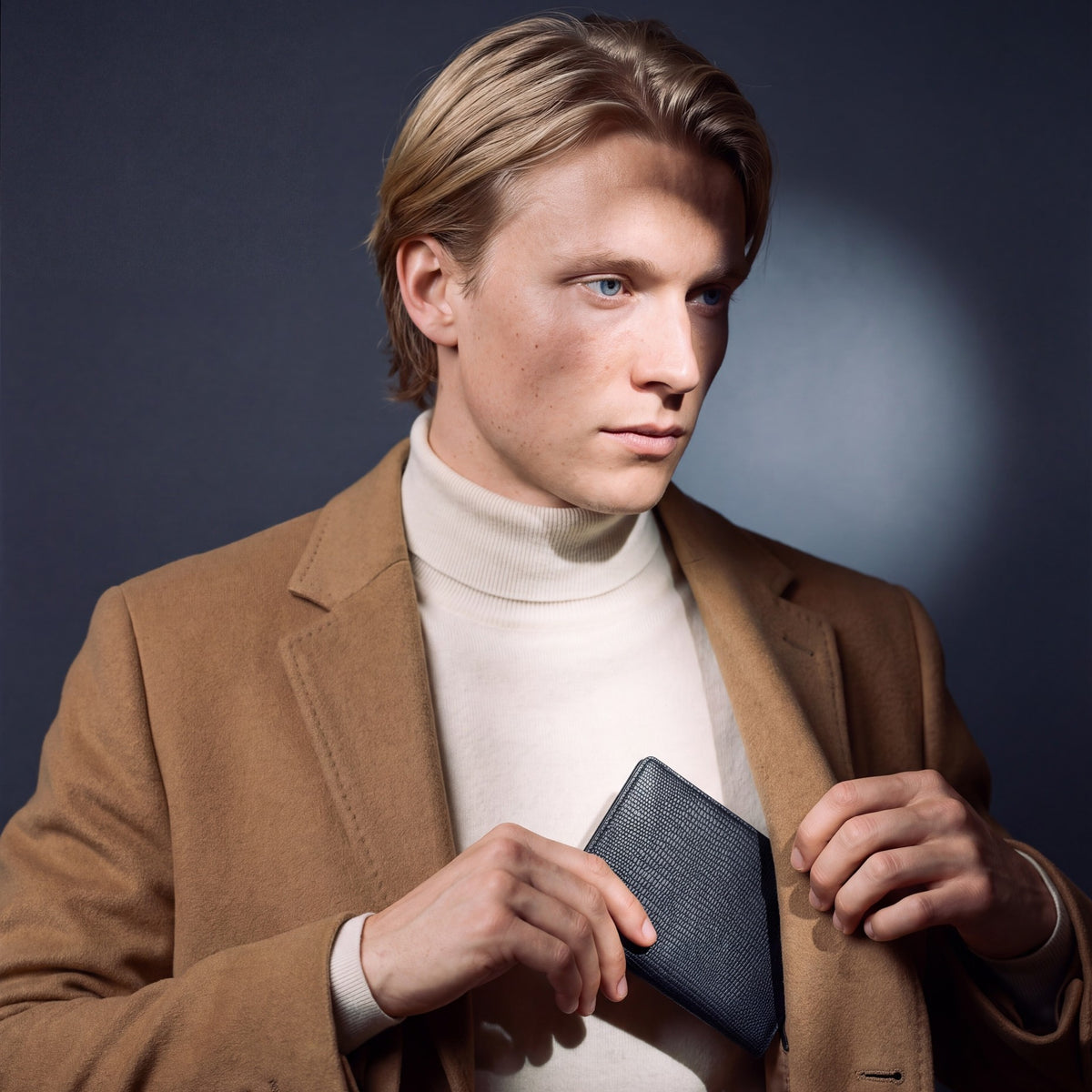 Man sliding a black lizard-embossed leather passport holder by GENTCREATE into a coat pocket