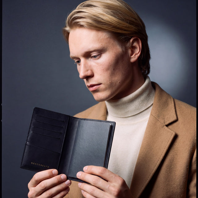 Man opening a black lizard leather passport holder by GENTCREATE with a passport inside