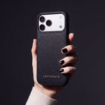 Hand with black nails holding a black Saffiano cross-hatch calfskin iPhone 18 Pro Max case by GENTCREATE