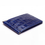 Closed blue glossy crocodile-embossed leather money clip wallet by GENTCREATE with its silver clip, on white