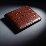 Close-up of the leather grain of a brown crocodile-embossed leather bifold wallet by GENTCREATE