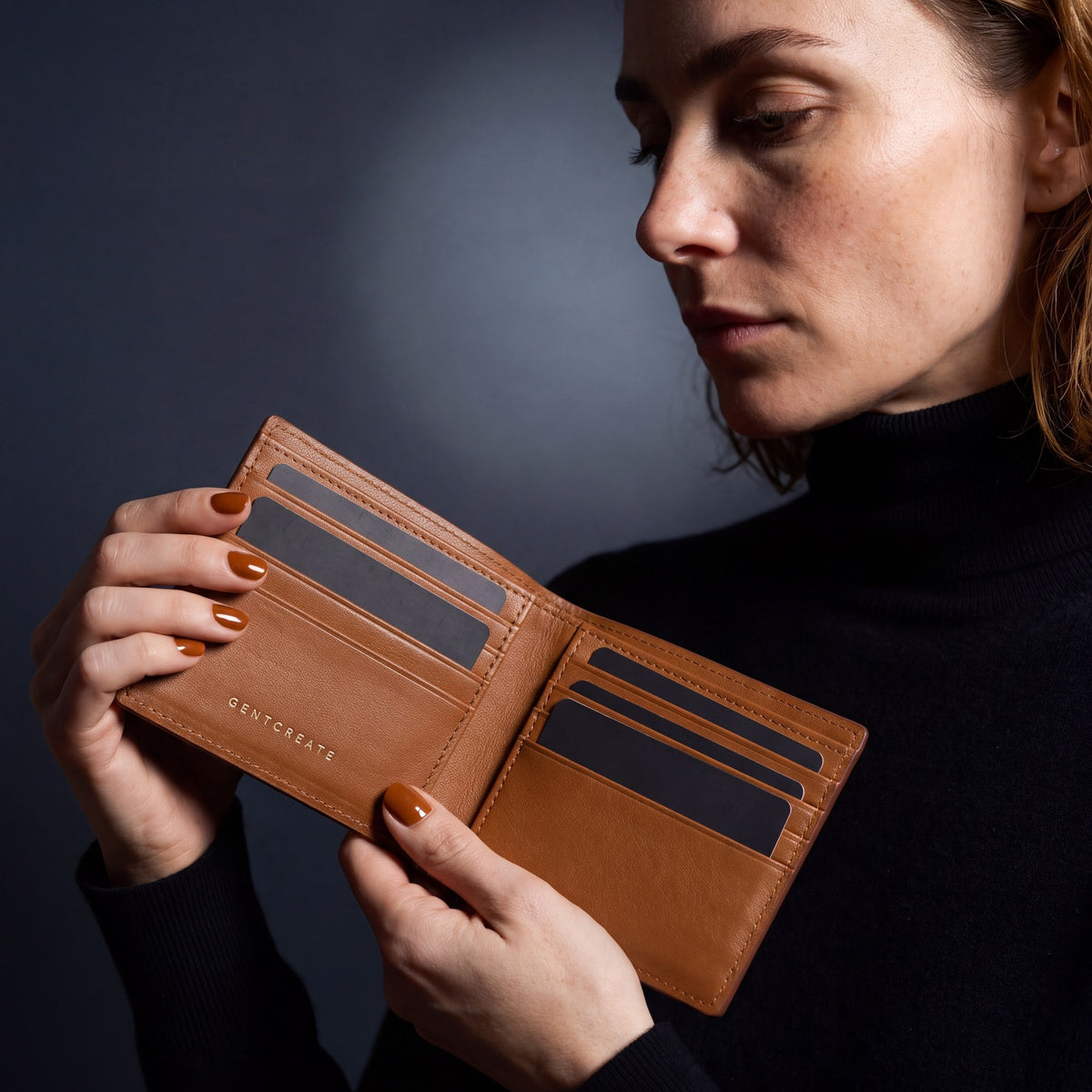Woman opening a brown Saffiano leather bifold wallet by GENTCREATE to show the card slots