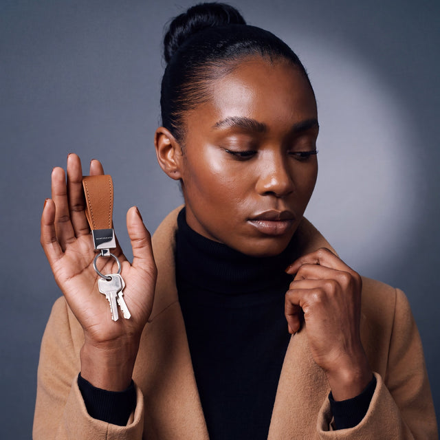 Woman heading out with house keys on a brown Saffiano leather keychain by GENTCREATE