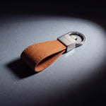 Close-up of the steel clasp of a brown Saffiano leather keychain by GENTCREATE