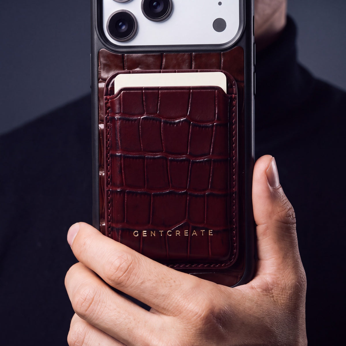 Close-up of a burgundy crocodile-embossed leather MagSafe wallet by GENTCREATE on the back of a phone