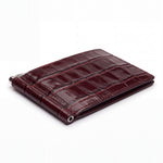 Closed burgundy glossy crocodile-embossed leather money clip wallet by GENTCREATE with its silver clip, on white