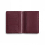 Open burgundy lizard-embossed leather passport holder by GENTCREATE showing the passport sleeve and card slots, on white